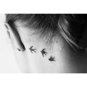 Vogel Tattoo hinter dem Ohr