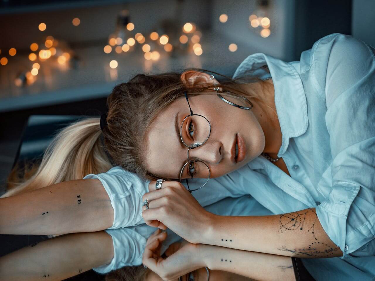 Woman Leaning on Glass Table